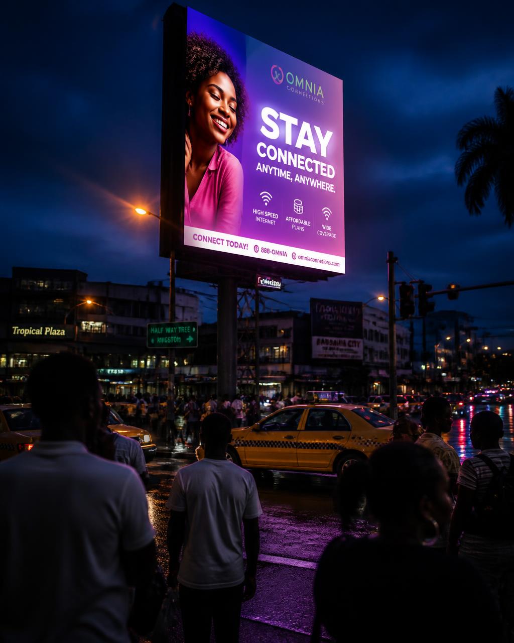 Bright outdoor digital screen glowing at dusk over a busy Jamaican intersection with a crowd nearby